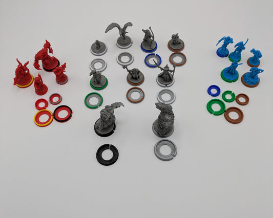 Full set of 115 color-coded bases for Battle of Five Armies, organized by faction and shown under original miniatures on battlefield.
